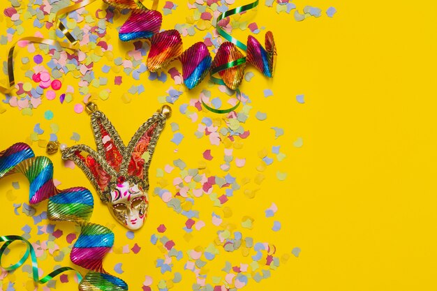 Carnival mask with confetti and serpentine