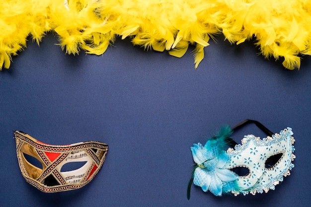 Carnival masks with yellow feather boa