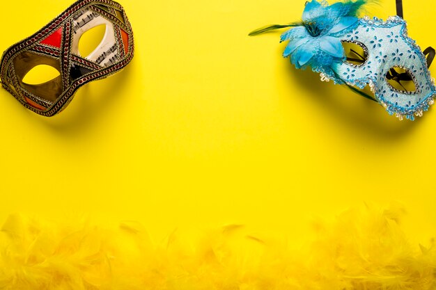 Carnival masks on yellow background