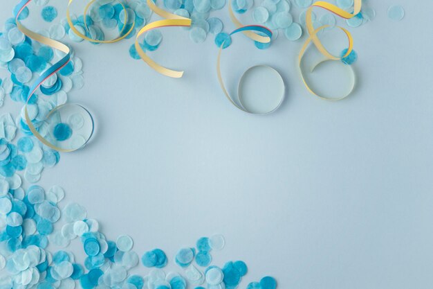 Carnival paper blue confetti and ribbons copy space