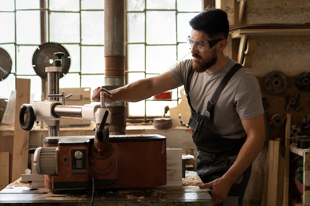 Carpenter cutting mdf board inside workshop