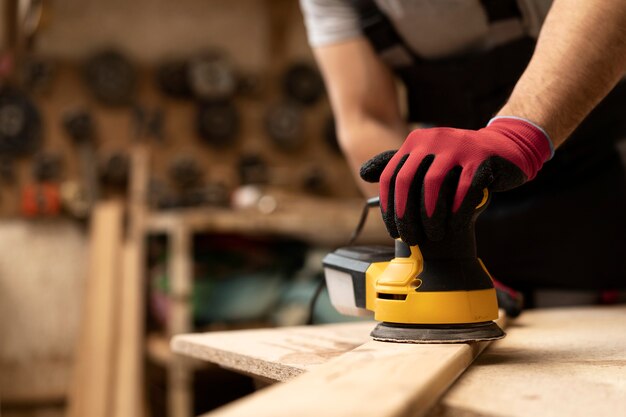 Carpenter cutting mdf board inside workshop