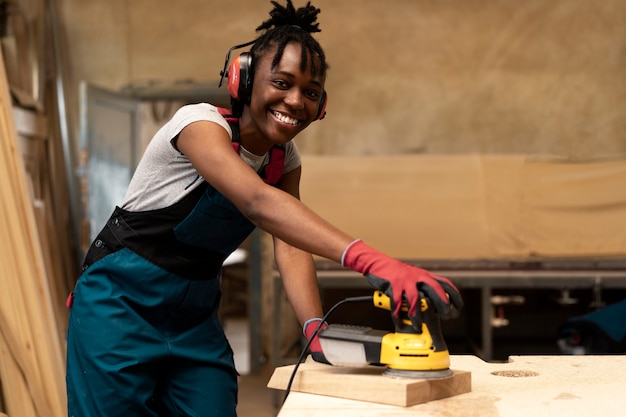 Carpenter cutting mdf board inside workshop