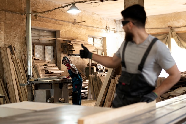 Carpenter cutting mdf board inside workshop