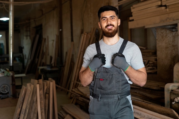 Carpenter cutting mdf board inside workshop