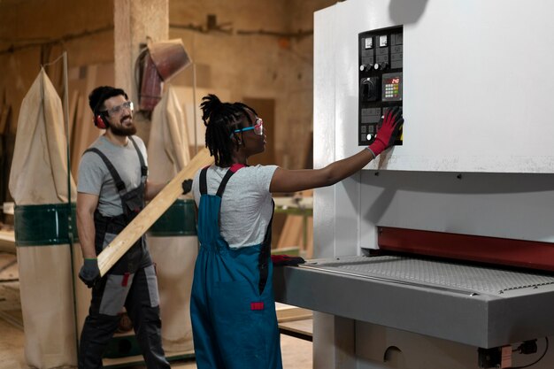 Carpenter cutting mdf board inside workshop