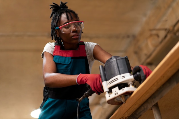 Carpenter cutting mdf board inside workshop