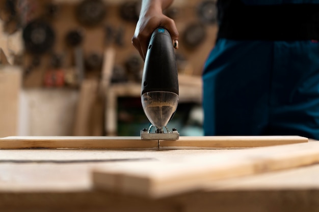 Carpenter cutting mdf board inside workshop