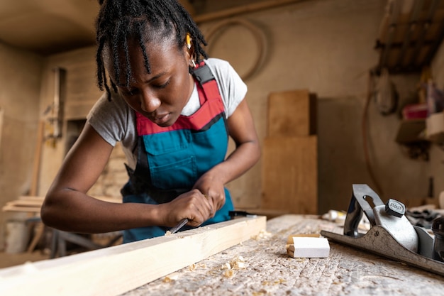 Carpenter cutting mdf board inside workshop