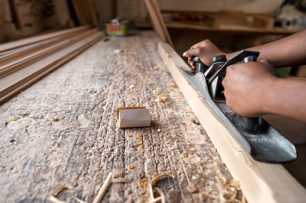 Carpenter cutting mdf board inside workshop