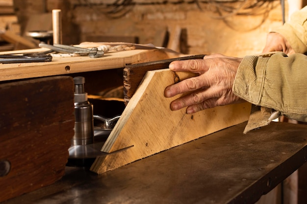 Free photo carpenter cutting wood