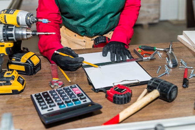 Carpenter making some esquise for future furnitures Premium Photo