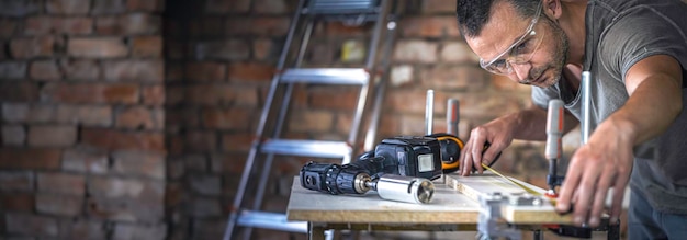 A carpenter in the process a professional tool for precision drilling in wood