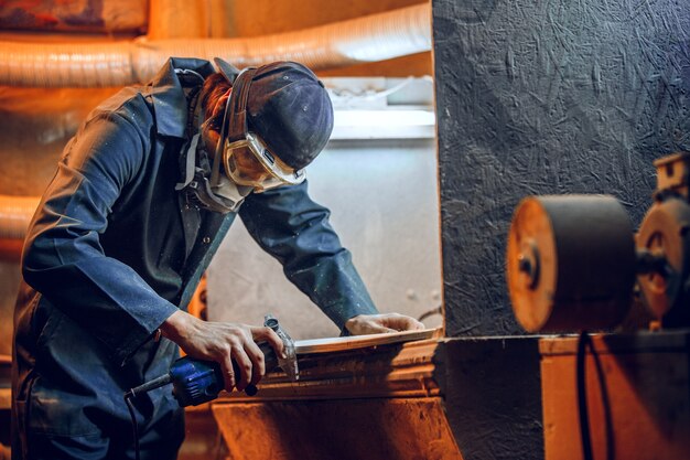 Carpenter using circular saw for cutting wooden boards. Construction details of male worker or handy man with power tools