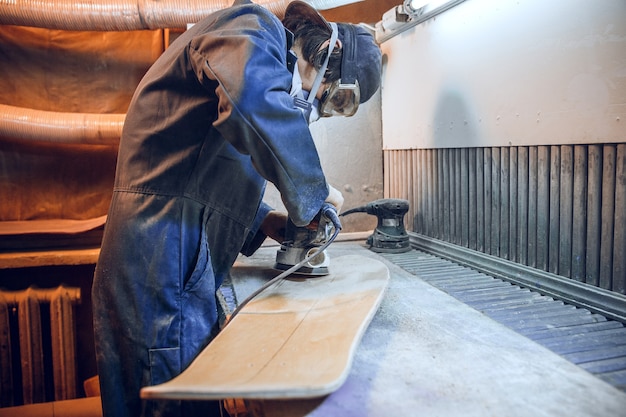 Carpenter using circular saw for cutting wooden boards. Construction details of male worker or handy man with power tools