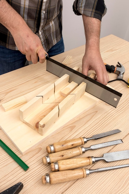 Free photo carpenter worker creating home decoration from wood in his workshop