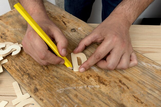 Carpenter worker making a d letter