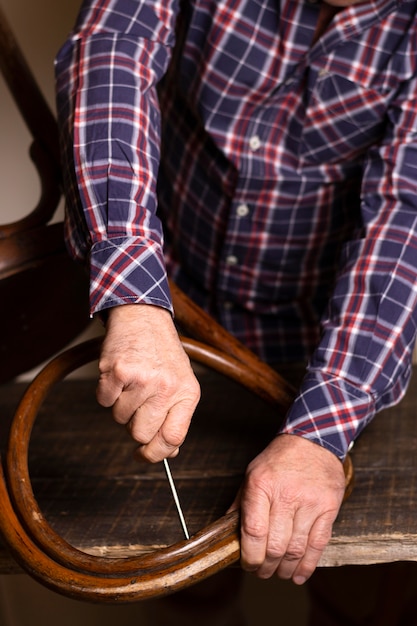 Carpenter working on a chair high view