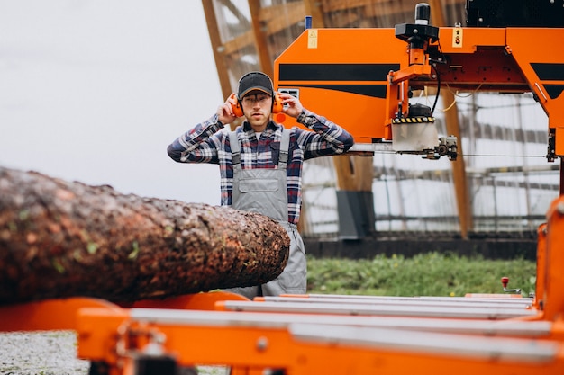 Free photo carpenter working on a sawmill on a wood manufacture