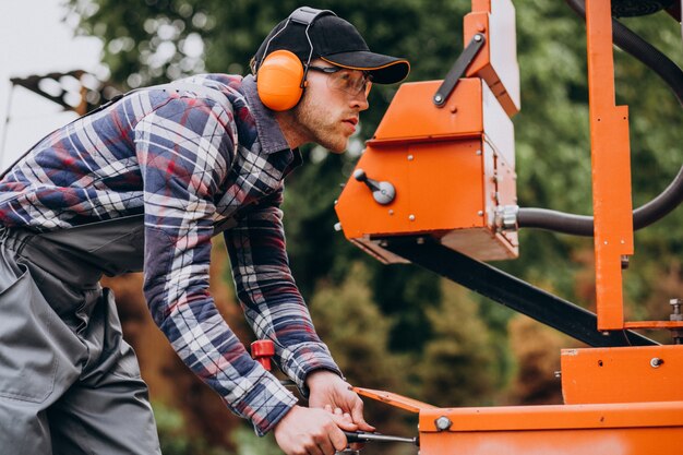 Carpenter working on a sawmill on a wood manufacture