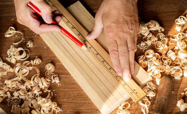 Carpenter working using a ruler and pencil