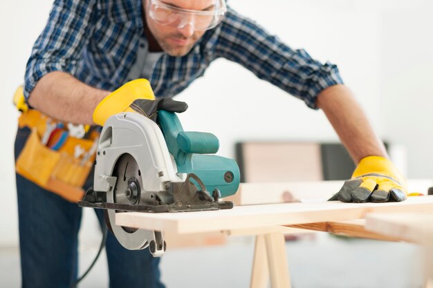 Carpenter working with circular saw