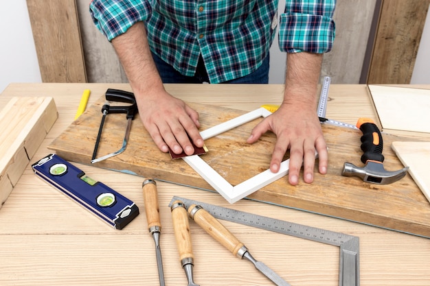 Foto gratuita falegname che lavora su legno nella sua bottega