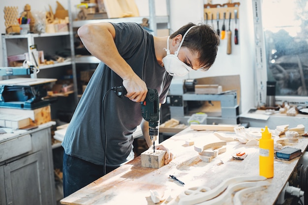 The carpenter works with a tree