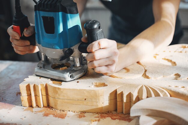 The carpenter works with a tree