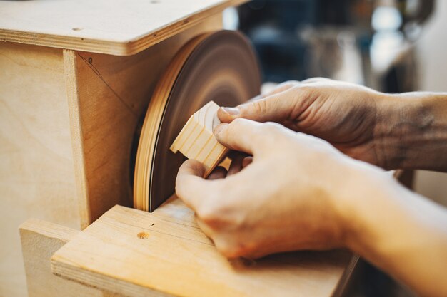 The carpenter works with a tree