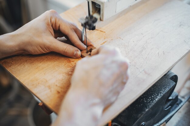 The carpenter works with a tree