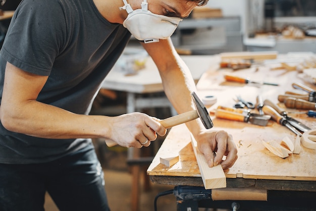 The carpenter works with a tree