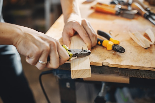 The carpenter works with a tree