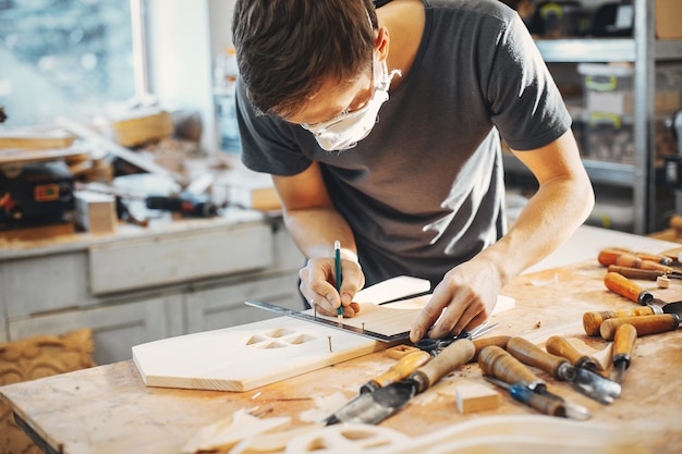 The carpenter works with a tree