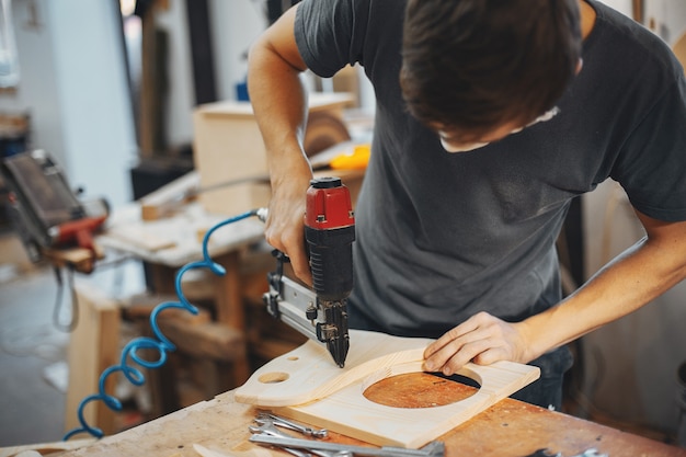 The carpenter works with a tree