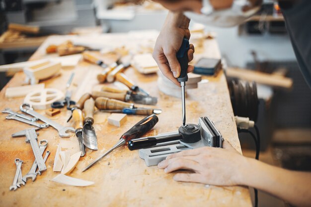 The carpenter works with a tree