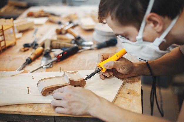 The carpenter works with a tree