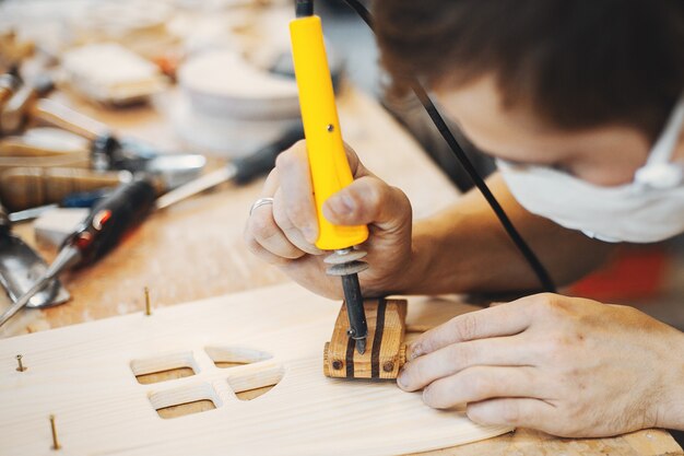 The carpenter works with a tree