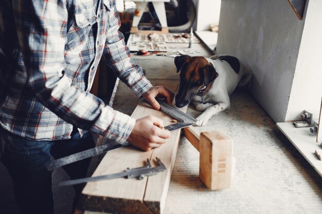 The carpenter works with a tree