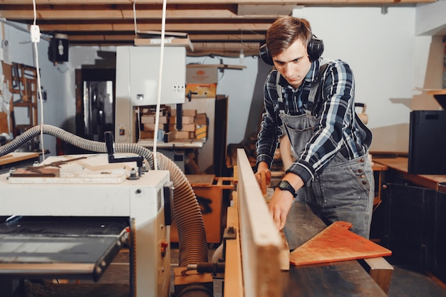 The carpenter works with a tree