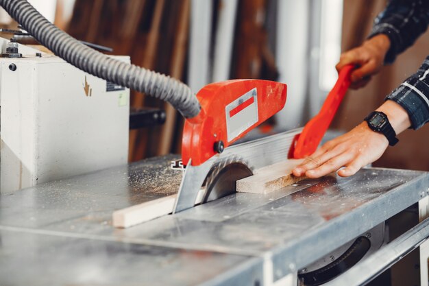 The carpenter works with a tree