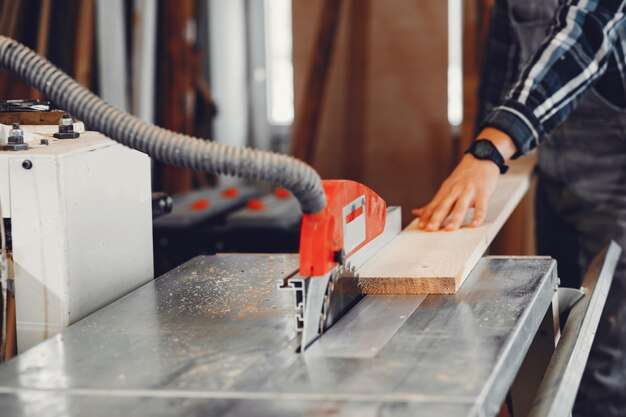 The carpenter works with a tree