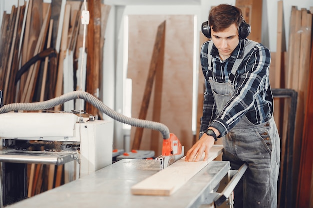 The carpenter works with a tree