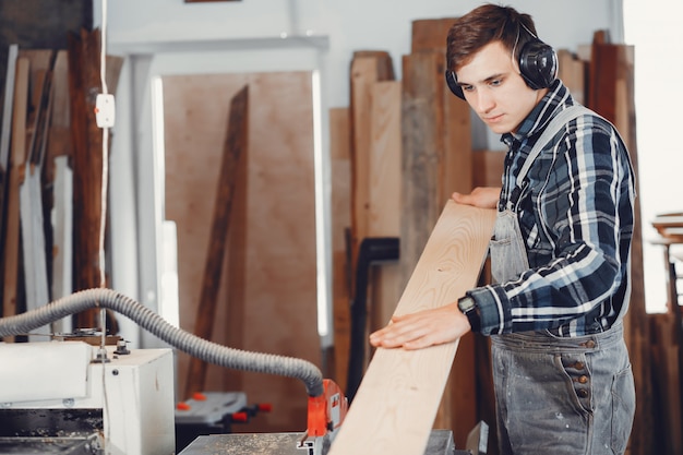 The carpenter works with a tree