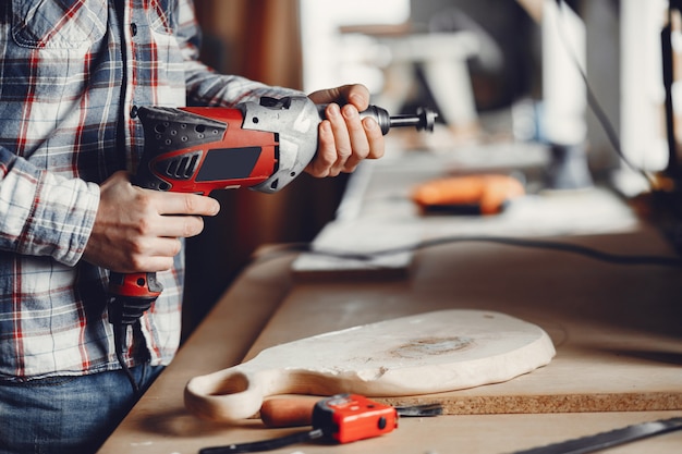 The carpenter works with a tree