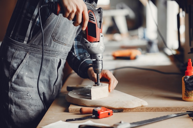 The carpenter works with a tree