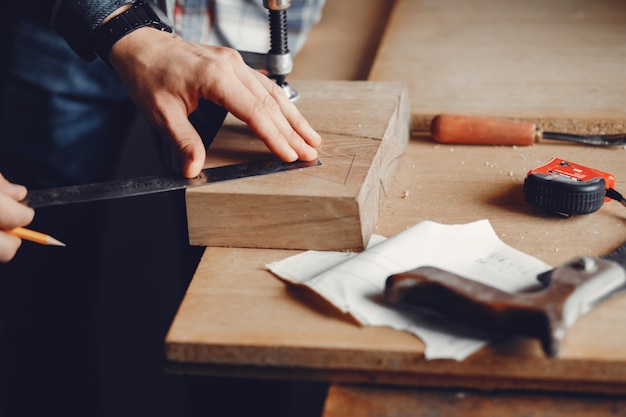 The carpenter works with a tree