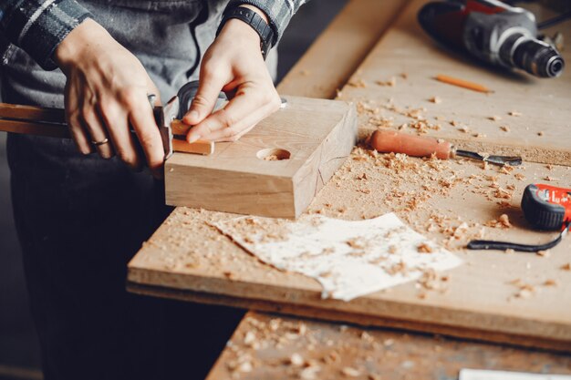 The carpenter works with a tree