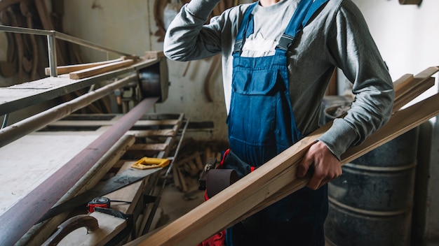 Free photo carpentry concept with man in garage