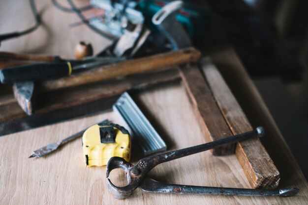 Carpentry concept with pliers and tape measure